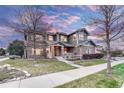 Attractive home with stone and siding exterior, a covered porch, and a well-kept front yard at 10459 Rivington Ct, Lone Tree, CO 80124