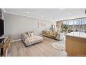 Inviting living room with neutral colors, hardwood floors, and large glass windows at 955 Eudora St # 307E, Denver, CO 80220