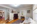Cozy living room with hardwood floors, fireplace, and staircase at 126 S Clarkson St, Denver, CO 80209