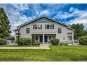 Two-story townhome with gray siding, blue trim, and well-maintained lawn and blue doors at 1419 Red Mountain Dr # 126, Longmont, CO 80504
