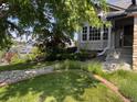Well manicured front yard with mature trees and front porch at 7636 S Allison Ct, Littleton, CO 80128