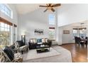 Bright living room with vaulted ceilings, large windows, and comfortable seating arrangement at 7636 S Allison Ct, Littleton, CO 80128