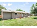 Ranch-style house with a well-maintained lawn, and a driveway leading to the attached garage at 4300 Osage St, Denver, CO 80211