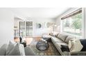 Bright living room featuring hardwood floors, large windows, and comfortable seating at 4300 Osage St, Denver, CO 80211