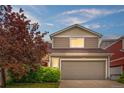 Inviting two-story home with a well-kept lawn and a convenient two-car garage at 5536 Kirk St, Denver, CO 80249