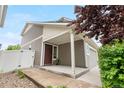 Attractive home with a covered porch entry, offering a warm welcome with a well-manicured garden at 5536 Kirk St, Denver, CO 80249