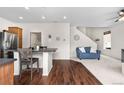 Open-concept living space combining hardwood floors, modern stairs, and stylish dining seating at 5536 Kirk St, Denver, CO 80249