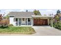 Cute bungalow features a light blue exterior, carport, and a well-maintained lawn at 1531 W Dakota Ave, Denver, CO 80223