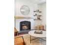 Cozy living room features a fireplace, hardwood floors, and modern furnishings at 623 S Logan St, Denver, CO 80209