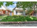 Charming home with a well-manicured lawn, beautiful landscaping, and a welcoming front entrance at 623 S Logan St, Denver, CO 80209
