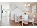 Charming dining area with a glass table, four chairs, and natural light, adjacent to the staircase at 451 Interlocken Blvd # 101, Broomfield, CO 80021