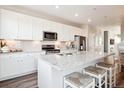 Beautiful kitchen with white cabinets, stainless steel appliances, granite countertops and a center island at 451 Interlocken Blvd # 101, Broomfield, CO 80021