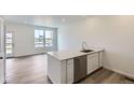 Kitchen includes new stainless appliances, hardwood floors, and quartz countertops at 6579 Parterre N Pkwy # 2, Thornton, CO 80602