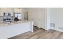 Modern kitchen featuring stainless steel appliances, granite counters, and sleek white cabinetry at 6579 Parterre N Pkwy # 2, Thornton, CO 80602