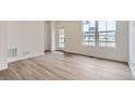 Bright and airy living room showcasing hardwood floors and ample natural light at 6579 Parterre N Pkwy # 2, Thornton, CO 80602