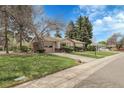 Inviting home with an attached garage, beautiful front yard and mature landscaping at 6832 S Birch Way, Centennial, CO 80122