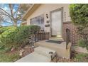 A cozy front porch highlights the entrance with a glass door and brick accents at 6832 S Birch Way, Centennial, CO 80122