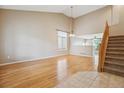 Inviting living room with high ceilings, hardwood floors, and large windows at 4016 S Rome St, Aurora, CO 80018