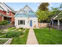 Inviting home with a walkway, beautiful lawn, and a charming front exterior at 2944 Hooker St, Denver, CO 80211