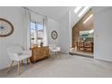 Open living room showcasing vaulted ceilings, neutral decor, brick accents, and dining area at 999 N Emerson St # 10, Denver, CO 80218
