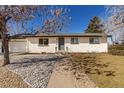 Charming single-story brick home with a well-manicured lawn and inviting front entrance, plus attached garage at 6699 S Pennsylvania St, Centennial, CO 80121