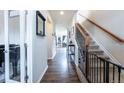 Bright entryway with hardwood floors, staircase, and access to other rooms at 1682 Dorothy Cir, Longmont, CO 80503