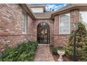 Brick walkway leads to arched entry with wrought-iron gate at 4272 E Orchard Pl, Centennial, CO 80121