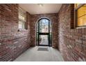 View through entryway shows brick walls and arched gate at 4272 E Orchard Pl, Centennial, CO 80121