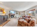 Cozy living room with a stone fireplace, comfortable seating, and natural light at 290 Broken Lance Dr # B202, Breckenridge, CO 80424