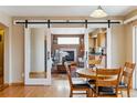 Cozy dining area offering views into a living room with fireplace and an adjacent kitchen area at 4901 Ashbrook Cir, Highlands Ranch, CO 80130