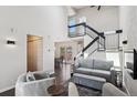 Spacious living room with wood floors, modern decor, and a staircase at 10309 W Fair Ave # E, Littleton, CO 80127
