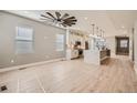 Bright living room with hardwood floors and a ceiling fan at 6917 Kendrick Ln, Arvada, CO 80007