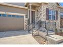 Attractive entryway and garage of this charming home with brick and siding exterior elements at 7693 S Quantock Way, Aurora, CO 80016