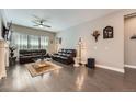 Elegant living room with hardwood floors, comfortable leather sofas, and stylish decor at 7693 S Quantock Way, Aurora, CO 80016