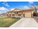 Inviting ranch style home with a spacious driveway and attached garage at 6545 Union St, Arvada, CO 80004