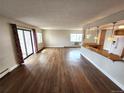 Spacious living room featuring wood floors, natural light, and an open layout, perfect for entertaining and relaxing at 13890 E Marina Dr # 602, Aurora, CO 80014