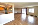 Inviting living room with hardwood floors, sliding glass doors, and an open connection to a modern, well-equipped kitchen at 13890 E Marina Dr # 602, Aurora, CO 80014