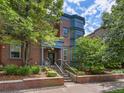 Beautiful brick home with landscaped front yard, covered porch, and eye-catching blue trim at 8450 E 29Th Ave, Denver, CO 80238