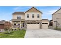 Charming two-story home featuring a stone facade, three-car garage, and a well-kept lawn at 5842 High Timber Cir, Castle Rock, CO 80104