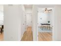 Bright hallway leading to an office with hardwood floors, a ceiling fan, and a gray and white rug at 6700 W Dorado Dr # 41, Littleton, CO 80123