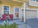 Inviting front porch with seating and an charming entrance to the house at 2508 Coach House Loop, Castle Rock, CO 80109