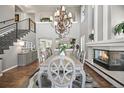 Elegant dining room with soaring ceilings, fireplace, and a large chandelier perfect for entertaining guests at 6242 Shea Pl, Highlands Ranch, CO 80130