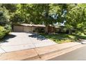 Beautiful single-story home with a well-maintained lawn and mature trees providing plenty of shade and curb appeal at 909 S Monroe St, Denver, CO 80209