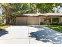 Spacious two-car garage with ample parking space on a wide driveway, surrounded by lush greenery at 909 S Monroe St, Denver, CO 80209