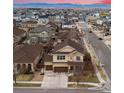 Beautiful aerial view of a tan two-story home with a two-car garage in a well-maintained neighborhood at 10995 Quintero St, Commerce City, CO 80022