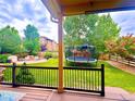 Lush backyard with a trampoline, fire pit, and ample space for outdoor activities and relaxation at 10995 Quintero St, Commerce City, CO 80022