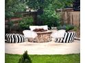 Cozy backyard fire pit area with comfortable seating, perfect for outdoor entertaining and relaxation at 10995 Quintero St, Commerce City, CO 80022