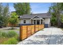 Exterior showcasing a charming home with a well-maintained fence and inviting curb appeal at 1456 Syracuse St, Denver, CO 80220