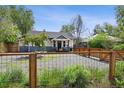 Landscaped front yard with gravel and a charming fence enhances the home's appeal at 1456 Syracuse St, Denver, CO 80220