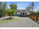 Charming home with gravel yard, nice landscaping, and a fence, creating curb appeal at 1456 Syracuse St, Denver, CO 80220